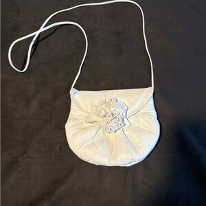 Chic White Leather Crossbody Bag with Floral Accent